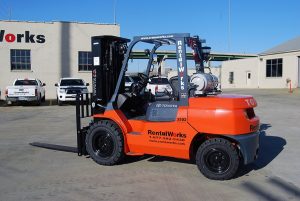 A Large Orange Truck Parked In A Parking Lot